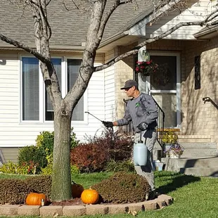 a man watering a tree