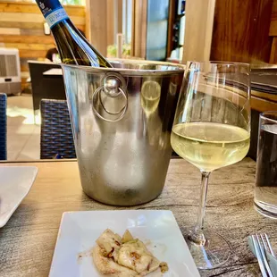 a plate of food and a glass of wine