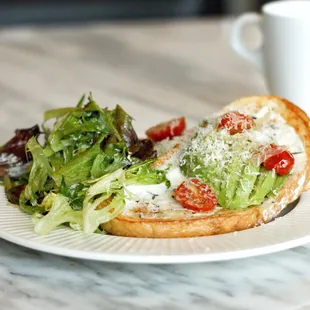 a plate of food and a cup of coffee