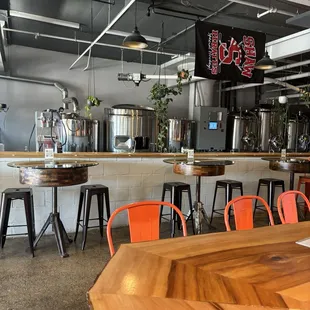 a bar with orange chairs