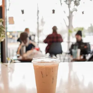 a cup of iced coffee on a table