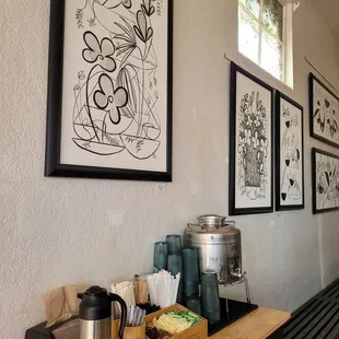 a coffee station with a coffee pot, coffee maker, and other items