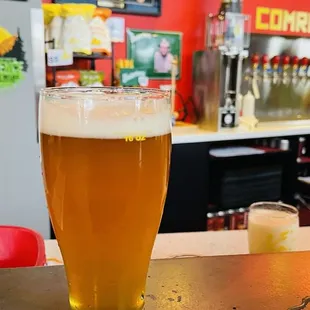 a glass of beer on a bar