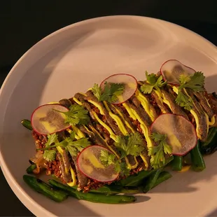 eggplant schnitzel (v+) 

panko + sesame crust, saffron yogurt, charred onion drizzle, blistered green bean salad, cilantro