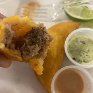 a hand holding a taco