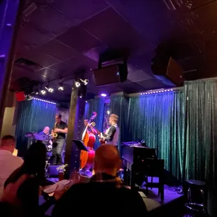 a group of musicians performing in a dimly lit room