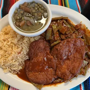 Tortitas de camarón served with nopalitos cooked in Chile Colorado and a side of lentejas y Spanish Rice.