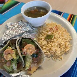 Shrimp tacos with crema de chipotle with pico de gallo and slice avocado. Served with a side of Spanish rice and a side of lentejas.