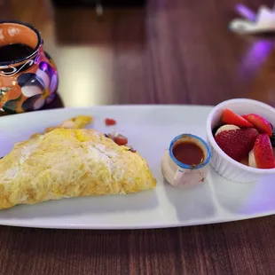 Omelet  with tomatoes, onions, jalapeños and mushrooms  and side of seasonal fruit and salsa roja