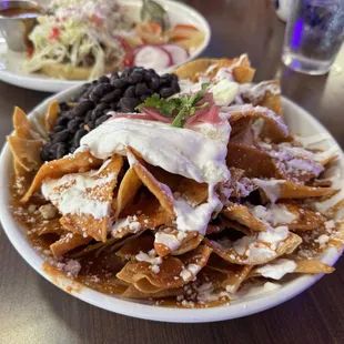 Chilaquiles rojos and a peek in the rear of sopes, mmmmDamn good food.