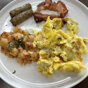 Shriveled up bacon and baby gray sausage. Interesting potatoes and brown eggs.