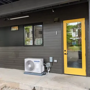 the outside of a house with a yellow door