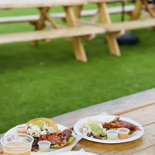 three plates of food on a picnic table