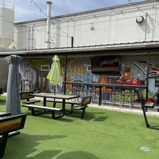 tables and umbrellas in front of a building