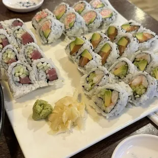 Four different kinds of rolls.  Boston Roll, Snow crab and avocado, Salmon and Avocado, Tuna and cucumber.