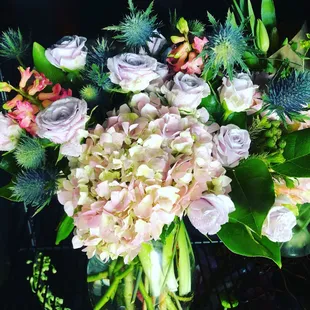Lavender roses, thistle, hot pink hyacinth, pink and lavender hydrangea, fresh tulips, Callalily's with lemon tip and buplurum.