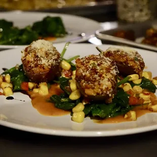 Indian Eggplant stuffed with quinoa and roasted vegetables, tomato gravy, wilted greens, corn and fennel ragout
