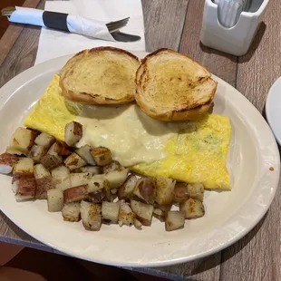 Western omelet with provolone cheese, home fries and croissant.