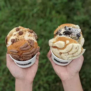 two hands holding ice cream cones