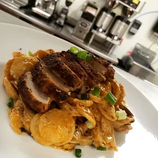 Blackened Chicken featuring sun-dried Tomato, sautéed mushrooms and orzo Pasta