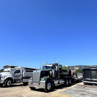 Couple of are trucks , is that a dinosaur on are trailer