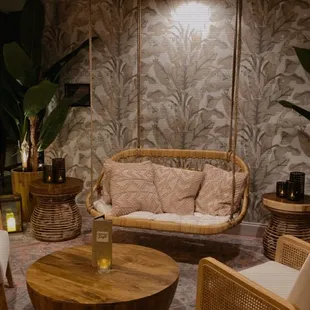 a living room with a canopy bed and wicker furniture