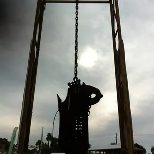 a large bell hanging from a wooden structure