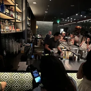 a group of people sitting at a bar