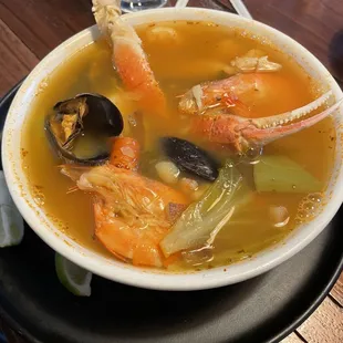 Seafood soup. Fresh seafood such as crab leg, shrimp, clams, and calamari complemented with potatoes, and carrots.