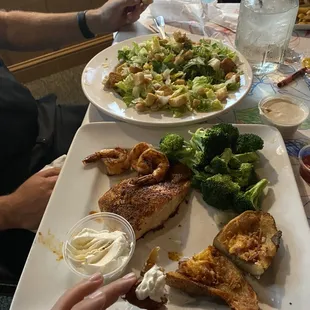 We shared a large chicken Caesar salad, and the salmon dinner that could with shrimp and two sides. It was delicious :)