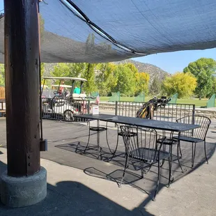 a patio area with a table and chairs