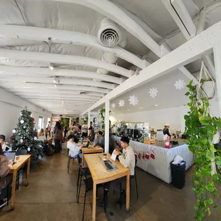 people sitting at tables in a coffee shop