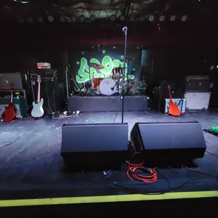 a stage with a guitar and a microphone