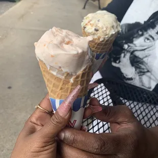 a woman holding a cone of ice cream