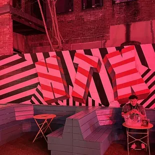 a pink and black striped bench