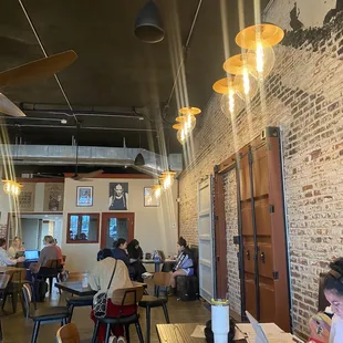 people sitting at tables in a coffee shop