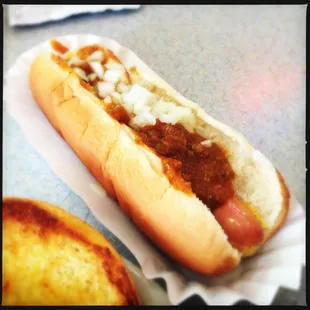 a hot dog with chili and onions
