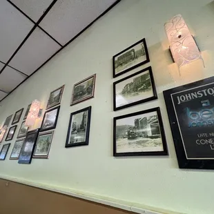 a wall of framed photographs