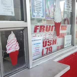 a large ice cream cone in a window
