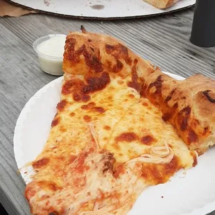 two slices of pizza on paper plates