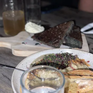 The hummus covered in micro greens that they had no idea what they were, stale pita. In the back the star of the night corn bread.
