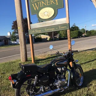 a motorcycle parked in front of a sign