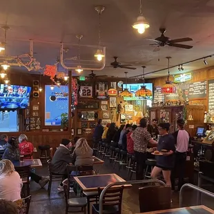 a crowded restaurant with people sitting at tables