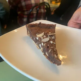 a slice of chocolate cake on a white plate