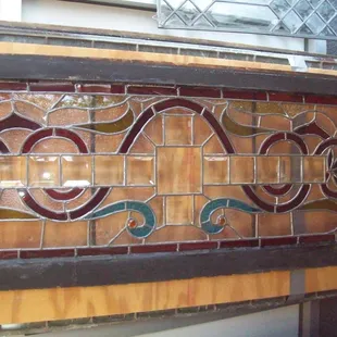 Stained and beveled leaded transom window.