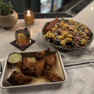 Smoked Chicken Wings and Southwest salad with Salmon. A very tasty salad. Very light salad dressing and unique fresh cornbread croutons.