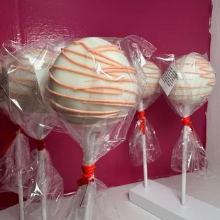 three lollipops wrapped in plastic