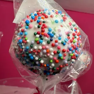 a close up of a cake pop covered in sprinkles