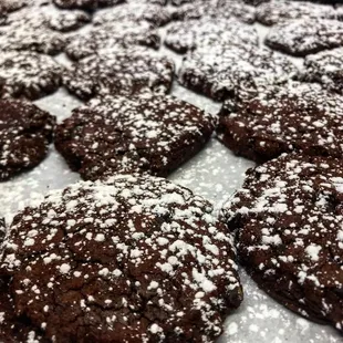 chocolate cookies covered in powdered sugar