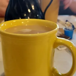 Foreground: hot tea Background: orange juice